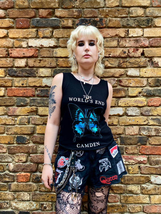 Person wearing a black tank top with a butterfly design.